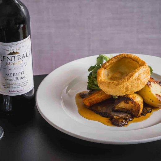 Inviting dinner setting with a warm dish and wine at Queens Hotel